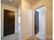 Hallway featuring neutral walls and carpet connects bedrooms and bathroom at 220 W Lawyers Rd, Monroe, NC 28110