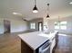 Modern kitchen island features a stainless sink, dishwasher, and beautiful white countertops at 220 W Lawyers Rd, Monroe, NC 28110