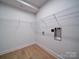Spacious laundry room features wire rack shelving and white trim at 220 W Lawyers Rd, Monroe, NC 28110