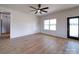 Open-concept living space with light wood floors, a ceiling fan and a black glass exterior door at 220 W Lawyers Rd, Monroe, NC 28110