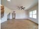 Bright, open living room features beautiful floors, a ceiling fan, and plenty of natural light at 220 W Lawyers Rd, Monroe, NC 28110