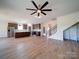 Open concept living room with wood floors and a view of the kitchen and staircase at 220 W Lawyers Rd, Monroe, NC 28110
