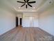 Large main bedroom features tray ceiling, fan, and barn door access to bath at 220 W Lawyers Rd, Monroe, NC 28110