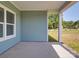 Covered patio of blue home offering ample room for outdoor seating at 220 W Lawyers Rd, Monroe, NC 28110