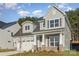 Charming two-story home with stone accents, well-manicured lawn, and attached garage at 1378 Cedardale Ln, Denver, NC 28037