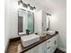 Bright bathroom featuring double sinks, wood counter, and modern fixtures at 2109 Rock Springs Cir, Denver, NC 28037