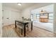 Bright dining area featuring hardwood floors and an open floor plan leading to the living room at 2109 Rock Springs Cir, Denver, NC 28037