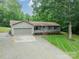 Ranch home with attached garage and driveway, surrounded by mature trees at 2109 Rock Springs Cir, Denver, NC 28037