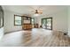 Spacious living room featuring hardwood floors, built-in shelving, and access to outdoor deck at 2109 Rock Springs Cir, Denver, NC 28037