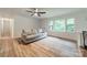 Bright living room with large windows, wood flooring and a comfortable sofa at 2109 Rock Springs Cir, Denver, NC 28037