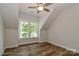 Attic showcasing hardwood floors, windows, and a ceiling fan at 4265 Candlewood Dr, Sherrills Ford, NC 28673