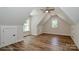 Attic showcasing hardwood floors, multiple windows, and a ceiling fan at 4265 Candlewood Dr, Sherrills Ford, NC 28673