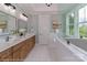 This is a bathroom with double sinks, wood cabinets, and a soaking tub at 4265 Candlewood Dr, Sherrills Ford, NC 28673