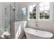 Bathroom features a standalone tub, a tiled shower, and plentiful light from the windows at 4265 Candlewood Dr, Sherrills Ford, NC 28673