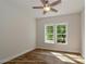 Bright bedroom features a ceiling fan, hardwood floors, and a window overlooking the outside at 4265 Candlewood Dr, Sherrills Ford, NC 28673