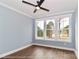 This bedroom includes a ceiling fan and three windows at 4265 Candlewood Dr, Sherrills Ford, NC 28673