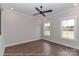 This bedroom features wood floors, a ceiling fan, and two windows at 4265 Candlewood Dr, Sherrills Ford, NC 28673