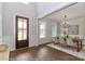 Bright dining room with hardwood floors, wainscoting, chandelier, and a view of the front door at 4265 Candlewood Dr, Sherrills Ford, NC 28673