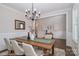 Cozy dining room with modern chandelier, hardwood floors, and ample seating around the table at 4265 Candlewood Dr, Sherrills Ford, NC 28673