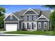 Charming two-story home with a manicured lawn, attached garage, and beautiful architectural details at 4265 Candlewood Dr, Sherrills Ford, NC 28673