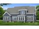 Rear exterior view with large windows and patio that provides a spacious view of the manicured lawn at 4265 Candlewood Dr, Sherrills Ford, NC 28673