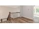 Hallway showcasing hardwood floors, a staircase, and natural light from the windows at 4265 Candlewood Dr, Sherrills Ford, NC 28673
