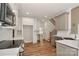 Spacious kitchen with stainless appliances, gray island, and hardwood floors, with staircase view at 4265 Candlewood Dr, Sherrills Ford, NC 28673