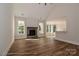 Open-concept living room with stone fireplace and hardwood floors, perfect for entertaining at 4265 Candlewood Dr, Sherrills Ford, NC 28673