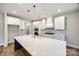 Spacious kitchen with white cabinets, island with sink, and gold light fixtures at 636 Edwards Rd, Fort Lawn, SC 29714