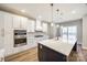 Modern kitchen with white cabinets, quartz countertops, and a large island at 636 Edwards Rd, Fort Lawn, SC 29714