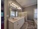 Well-lit bathroom features a double vanity and large mirror at 8468 Blades Trl, Denver, NC 28037