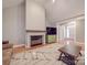 Bright living room featuring fireplace, television, and hardwood floors at 8468 Blades Trl, Denver, NC 28037