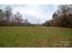 Open grassy area with windmill and trees in the background at 100 Steffey Ln, Taylorsville, NC 28681