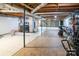 Unfinished basement with tiled floor, exposed pipes, and storage shelving at 100 Steffey Ln, Taylorsville, NC 28681