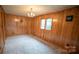 Simple bedroom with wood paneled walls and carpeted floors at 100 Steffey Ln, Taylorsville, NC 28681