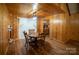 Charming dining room with hardwood floors and wood paneled walls at 100 Steffey Ln, Taylorsville, NC 28681