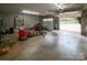 Attached garage with open overhead door, ample storage, and various tools at 100 Steffey Ln, Taylorsville, NC 28681