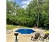 Inviting in-ground pool with ample surrounding patio space for lounging at 100 Steffey Ln, Taylorsville, NC 28681