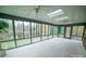 Bright sunroom overlooking a serene pond, with walls of windows at 100 Steffey Ln, Taylorsville, NC 28681