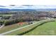 Aerial view showing a home's serene location amidst nature with mountain views in the background at 1485 Nc Hwy 16 N Hwy, Taylorsville, NC 28681