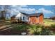 Home's back exterior, showcasing deck and landscaping at 1485 Nc Hwy 16 N Hwy, Taylorsville, NC 28681