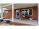 Brick front porch with a bench and autumn decorations at 1485 Nc Hwy 16 N Hwy, Taylorsville, NC 28681