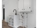 Functional laundry area with white cabinetry and exposed plumbing at 1485 Nc Hwy 16 N Hwy, Taylorsville, NC 28681