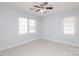 Neutral-toned bedroom features updated ceiling fan, fresh paint and windows at 1106 Chandler Dr, Rock Hill, SC 29732