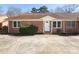 Brick exterior with front door and windows of a townhome, featuring a well-kept front yard at 1106 Chandler Dr, Rock Hill, SC 29732