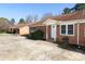 Charming brick exterior with well-maintained landscaping, a front door, and an adjacent concrete driveway at 1106 Chandler Dr, Rock Hill, SC 29732
