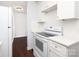 Well-lit kitchen features white cabinets, matching appliances, and dark wood-look floors at 1106 Chandler Dr, Rock Hill, SC 29732