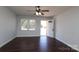 Bright living room with hardwood floors, ceiling fan, and entry door at 1106 Chandler Dr, Rock Hill, SC 29732