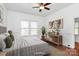 Bright bedroom featuring a ceiling fan and ample natural light at 12300 Caldwell Rd, Charlotte, NC 28213