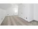 Bright bonus room with neutral walls, plush carpet, and vaulted ceiling at 12300 Caldwell Rd, Charlotte, NC 28213